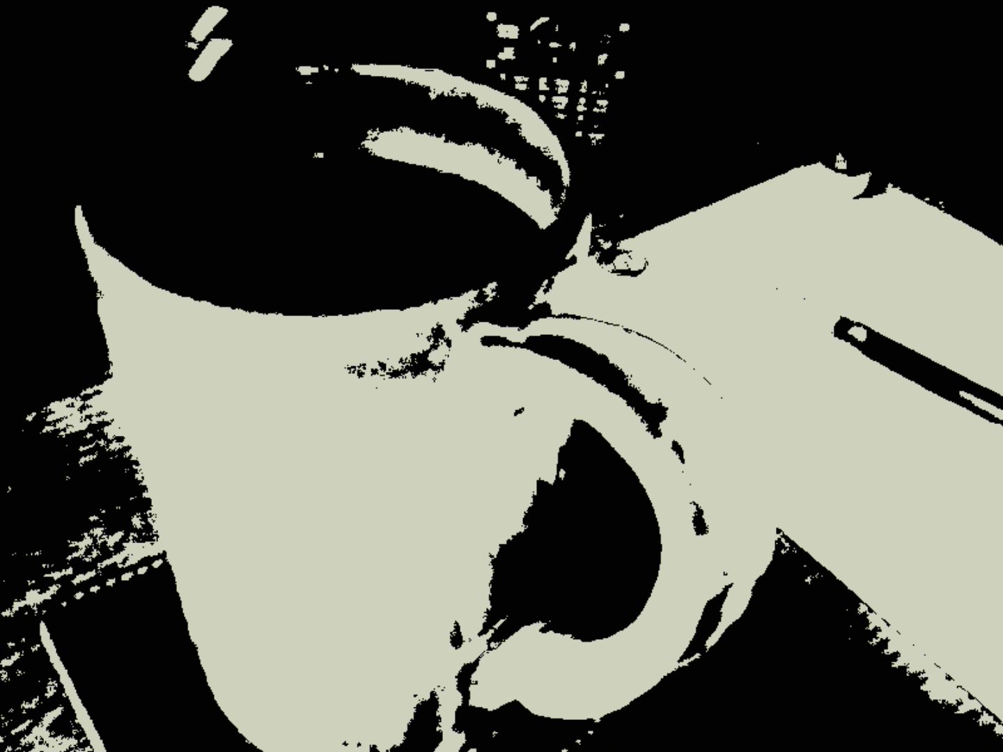 A wacky effect applied by the Kodak Charmera to an image of a coffee cup on a desk.