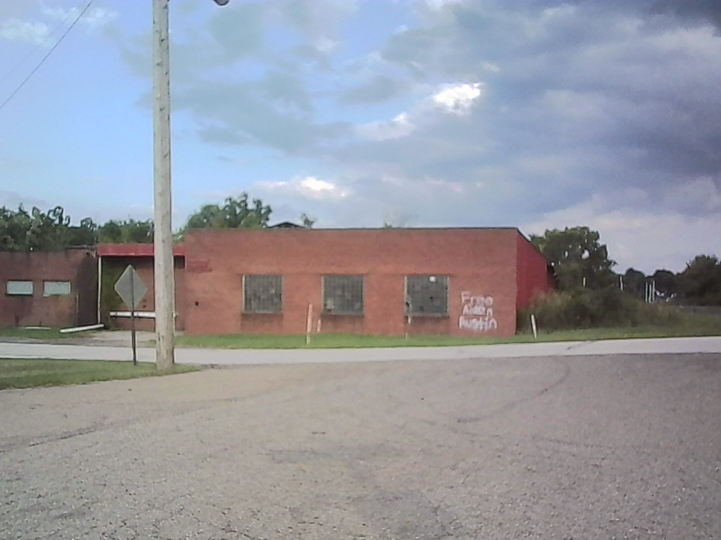 An industrial building of sorts that has been tagged. Who is Aiden Austin? Why must he be freed?